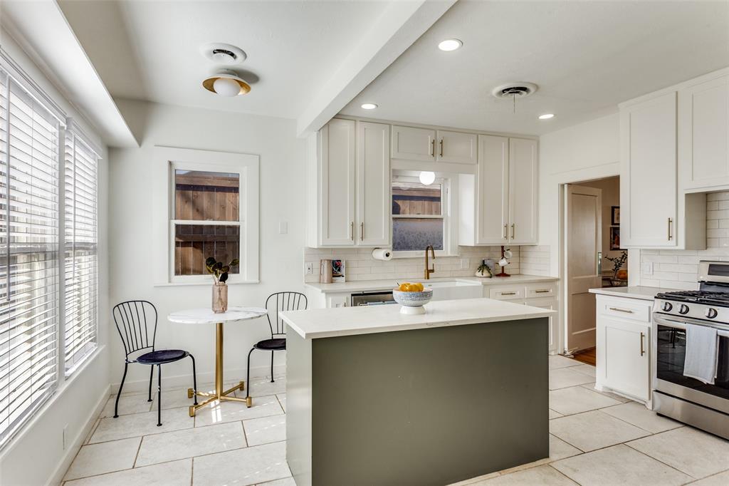 4601 Pershing Avenue Fort Worth, TX 76107 - Photo 10 of 28 a kitchen with stainless steel appliances kitchen island granite countertop a sink and cabinets