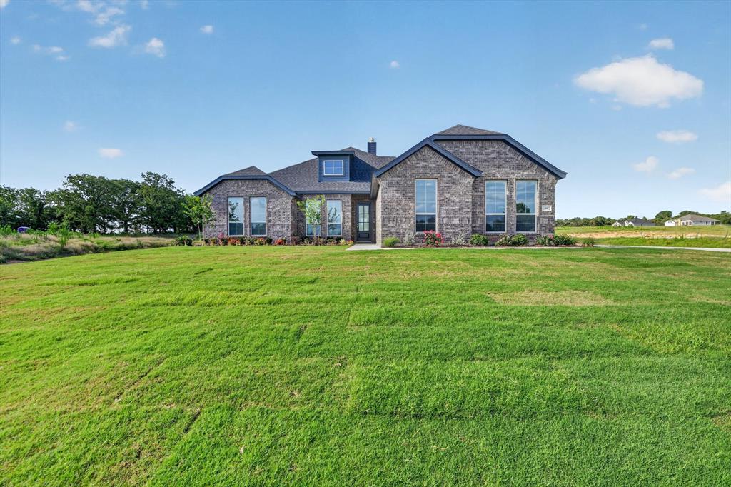 416 McAlpine Drive Springtown, TX 76082 - Photo 3 of 40 Contemporary brick exterior with a dark shingle roof, featuring prominent gables and dormer windows