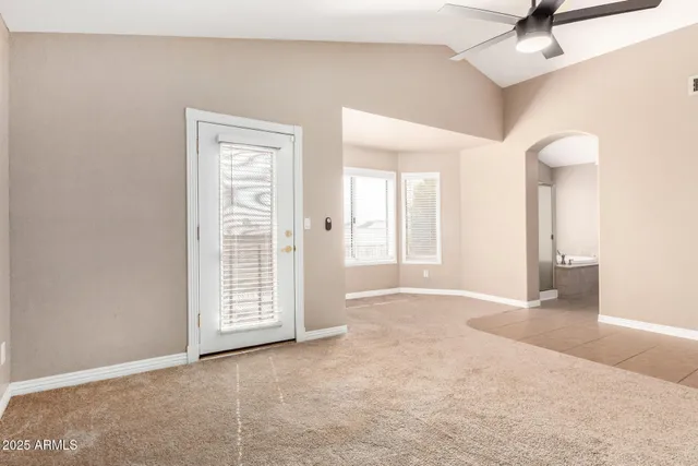 a view of an empty room with a ceiling fan