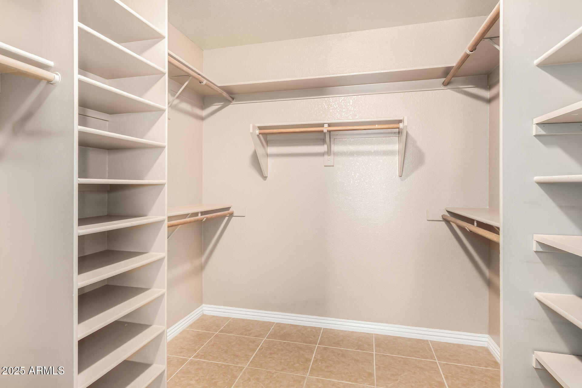 3013 East Bighorn Avenue Phoenix, AZ 85048 - Photo 17 of 40 a view of walk in closet with empty racks