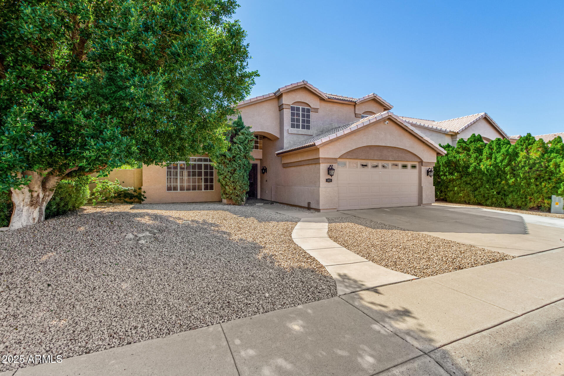 3013 East Bighorn Avenue Phoenix, AZ 85048 - Photo 2 of 40 a front view of a house with a yard and garage