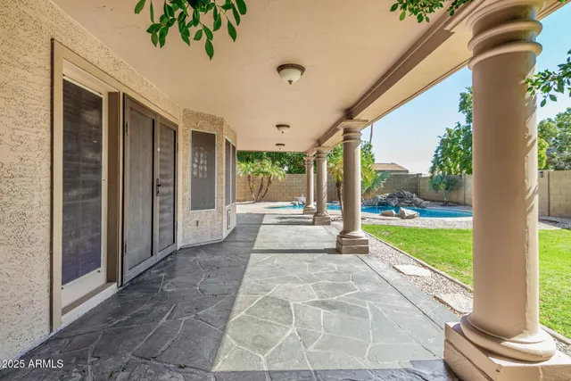 a view of a porch with a slide table and chairs