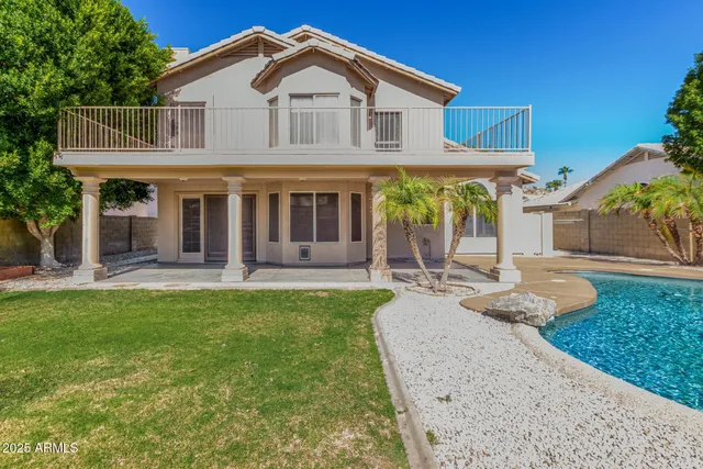 a view of a house with a backyard and a patio