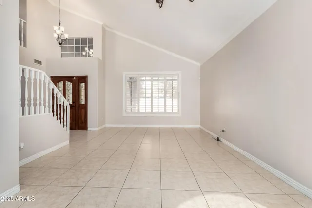 a view of empty room with wooden floor and fireplace