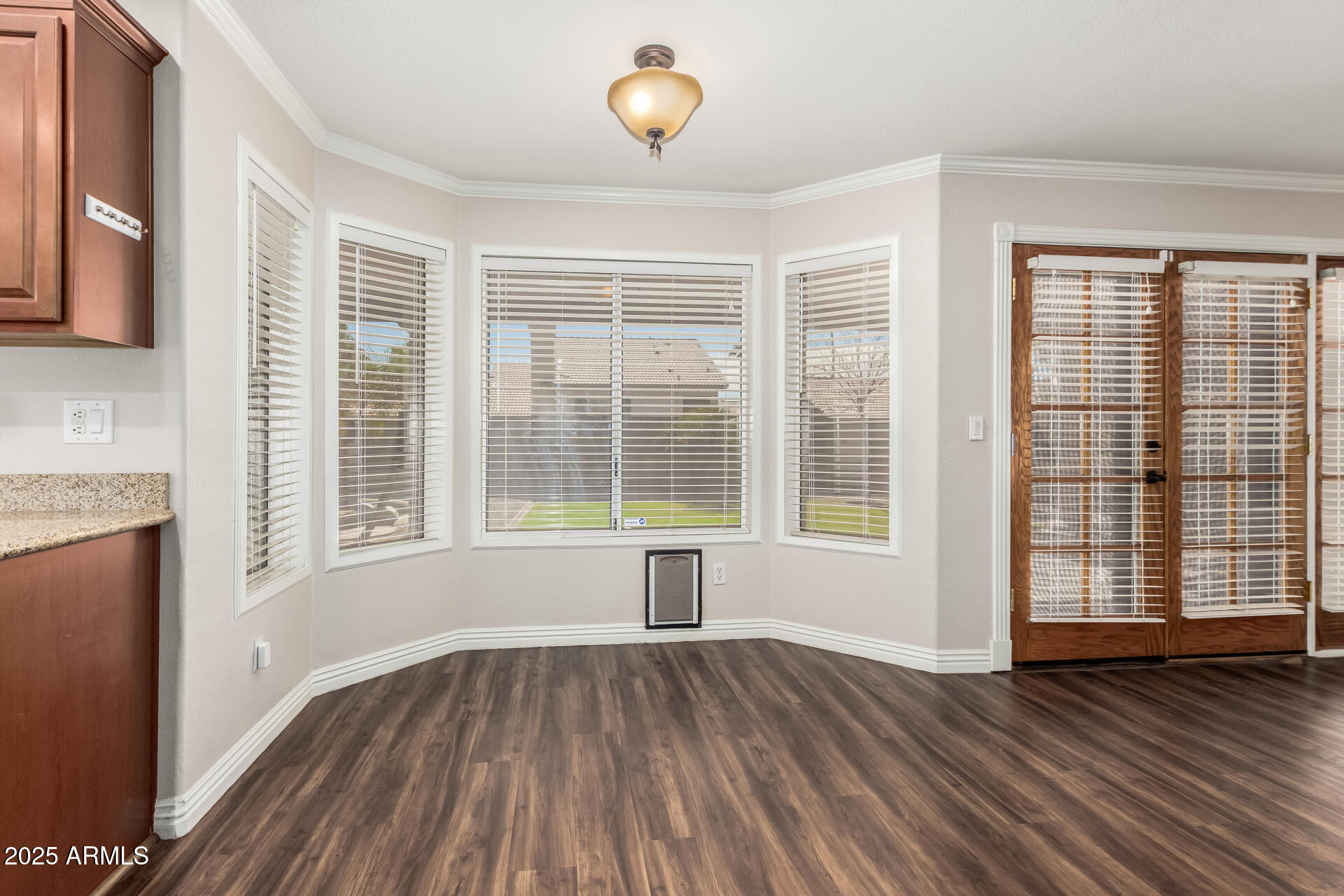 3013 East Bighorn Avenue Phoenix, AZ 85048 - Photo 9 of 40 a view of an empty room with wooden floor and a window