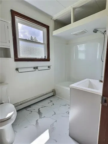 a bathroom with a toilet sink and vanity