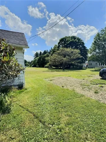 a view of a garden with a building in the background
