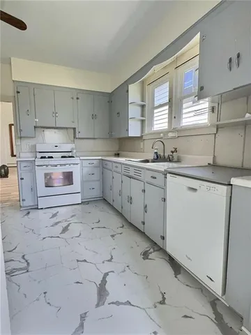 a kitchen with a sink stove and cabinets