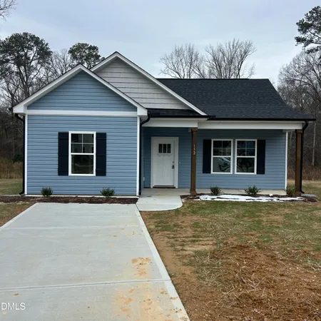 a view of a house with a backyard and porch