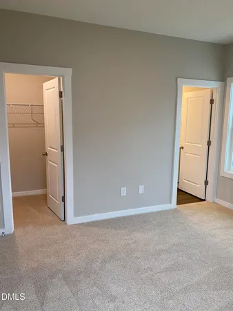 a view of an empty room and closet area