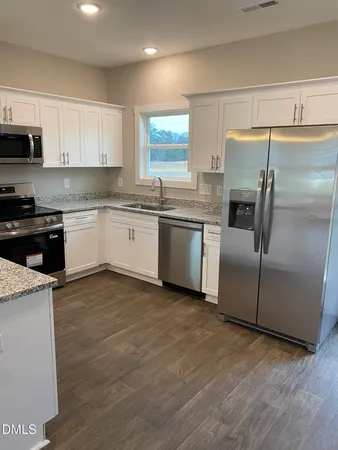 a kitchen with a sink stove and refrigerator