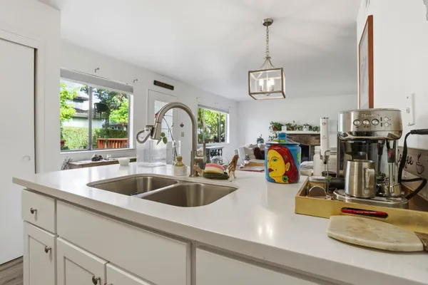 a view of a kitchen counter space a sink and wooden floor