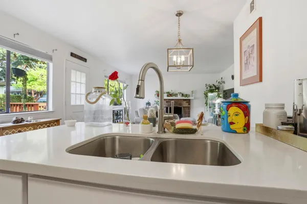 a kitchen with a sink a counter and windows