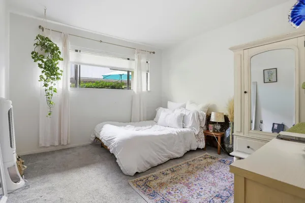 a bedroom with a bed table and a couch