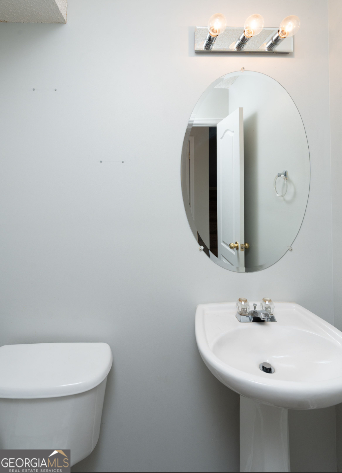 4414 Mitchells Ridge Drive Ellenwood, GA 30294 - Photo 11 of 25 a bathroom with a toilet sink and mirror