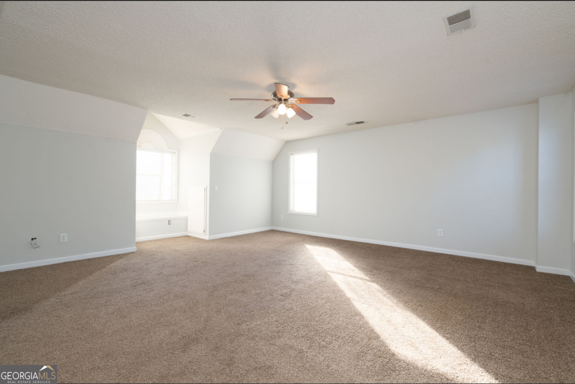 4414 Mitchells Ridge Drive Ellenwood, GA 30294 - Photo 14 of 25 an empty room with windows and ceiling fan