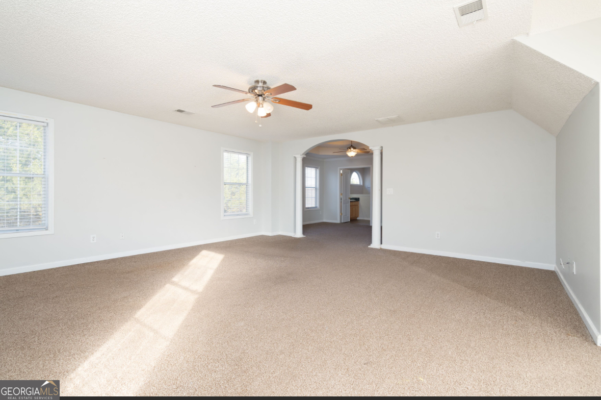 4414 Mitchells Ridge Drive Ellenwood, GA 30294 - Photo 16 of 25 a view of a big room with chandelier fan and windows