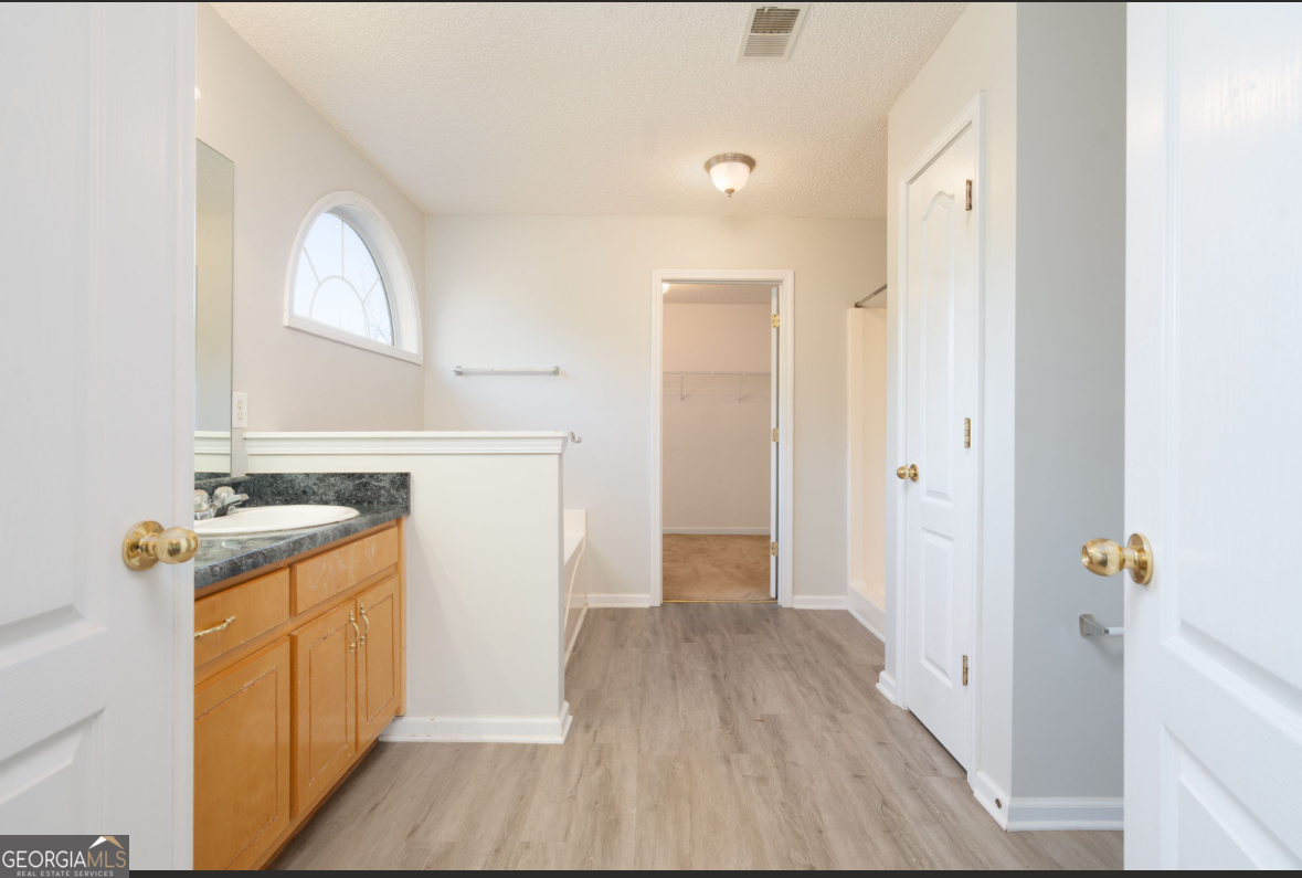 4414 Mitchells Ridge Drive Ellenwood, GA 30294 - Photo 17 of 25 a view of a hallway with wooden floor