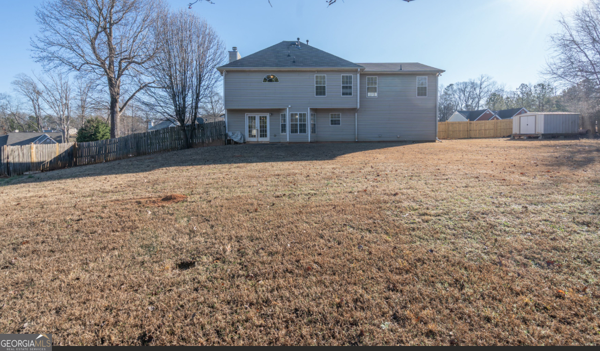 4414 Mitchells Ridge Drive Ellenwood, GA 30294 - Photo 22 of 25 a front view of a house with a yard and garage