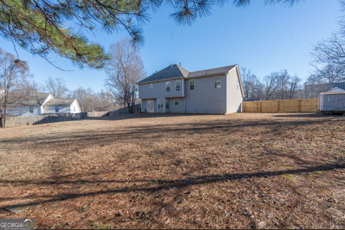 4414 Mitchells Ridge Drive Ellenwood, GA 30294 - Photo 23 of 25 a view of large house with a yard