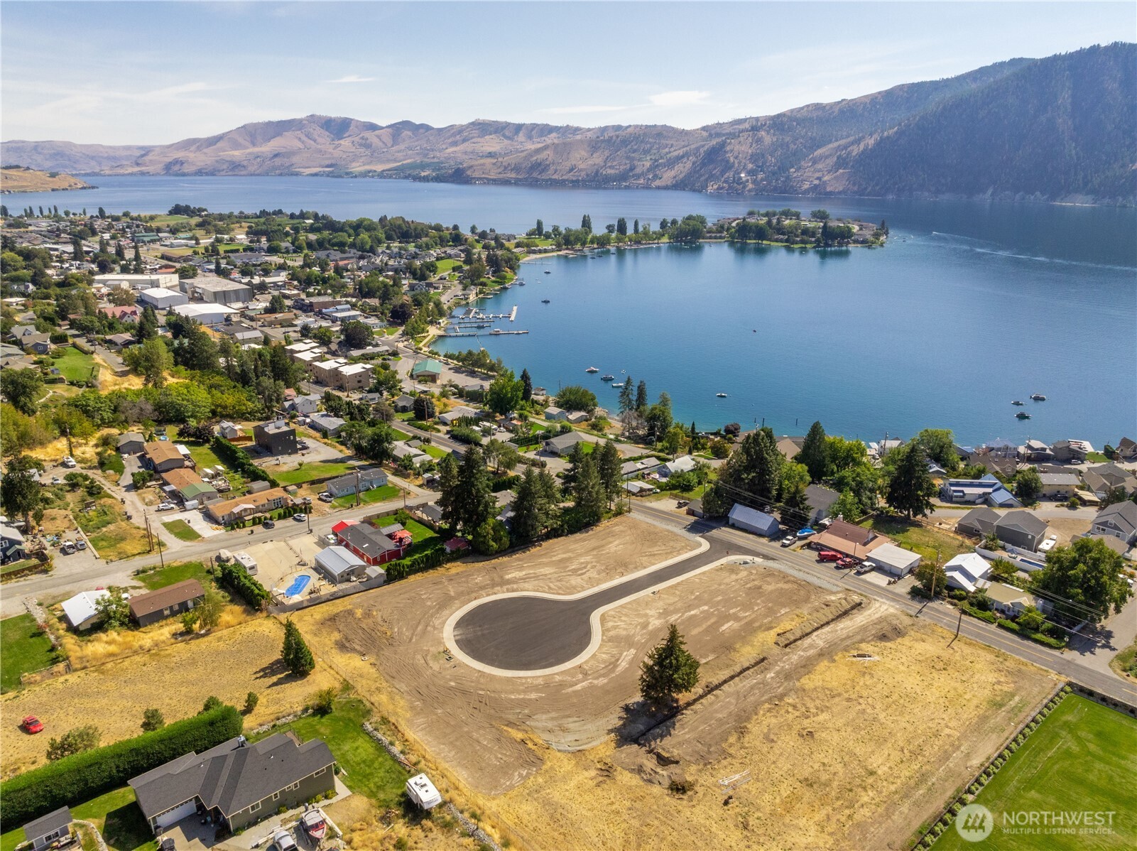 38 Indigo Lane Manson, WA 98831 - Photo 13 of 30 a view of a house with a yard and a lake view