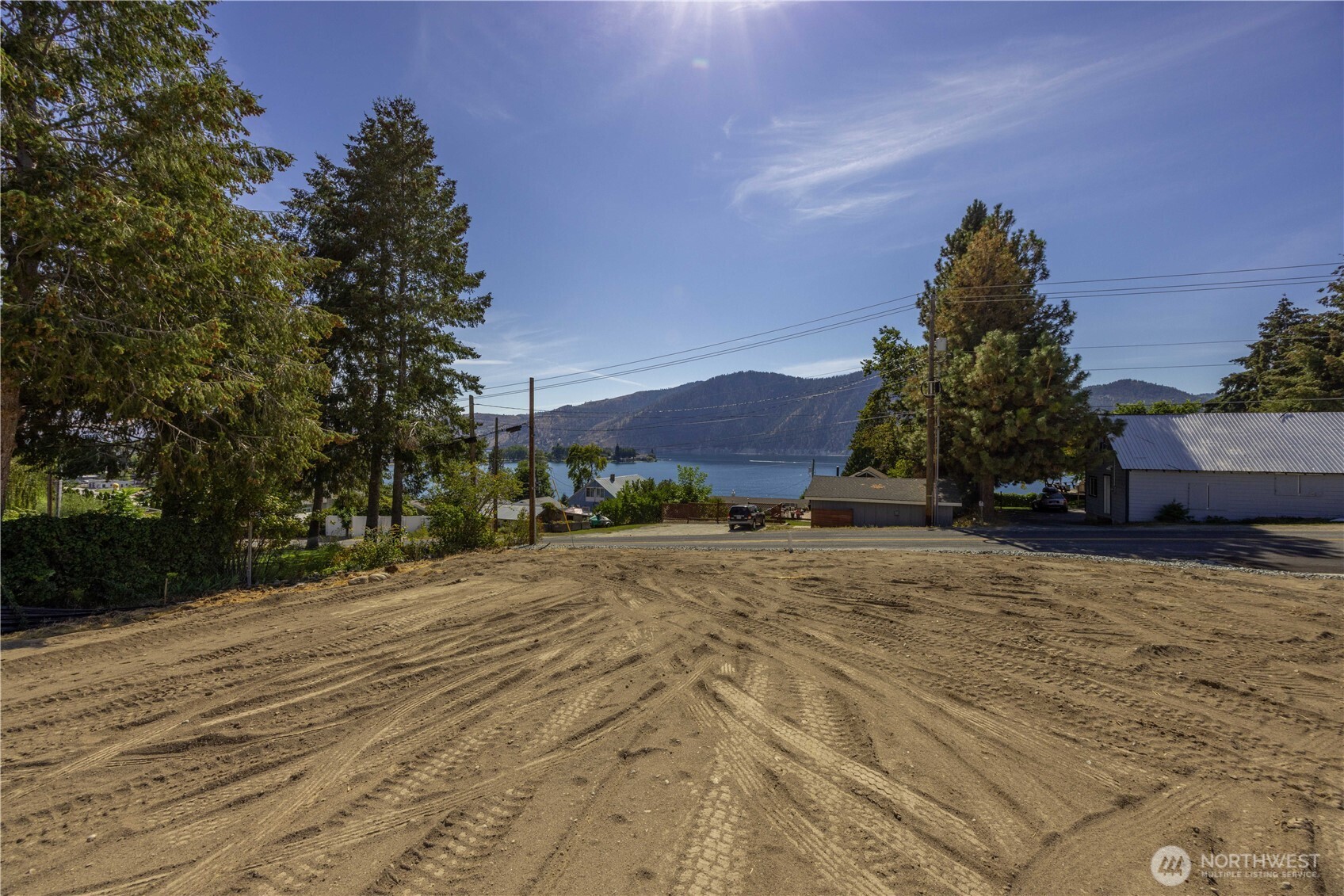 38 Indigo Lane Manson, WA 98831 - Photo 6 of 30 a street view with large trees