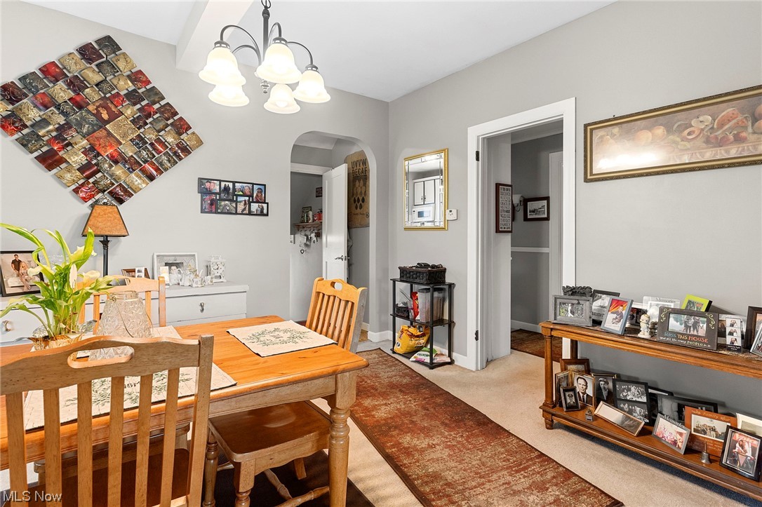 4275 West Calla Road Canfield, OH 44406 - Photo 13 of 31 Dining area with light carpet and a notable chandelier