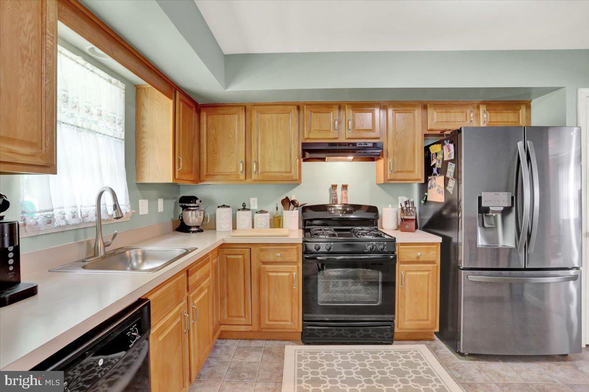 1017 Saylor Drive Temple, PA 19560 - Photo 12 of 36 a kitchen with a stove a sink and a refrigerator