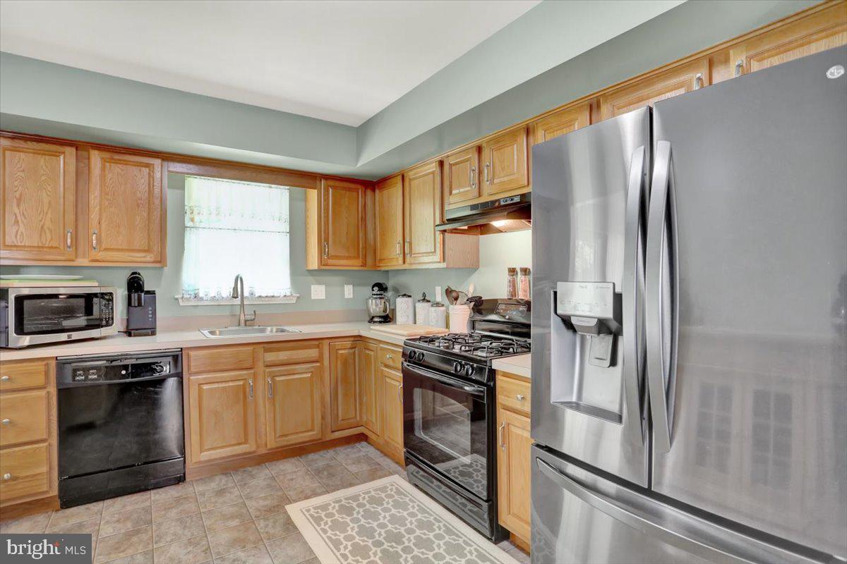 1017 Saylor Drive Temple, PA 19560 - Photo 10 of 36 a kitchen with a sink stove and refrigerator