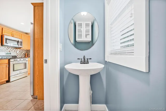 a bathroom with a sink a mirror and a toilet