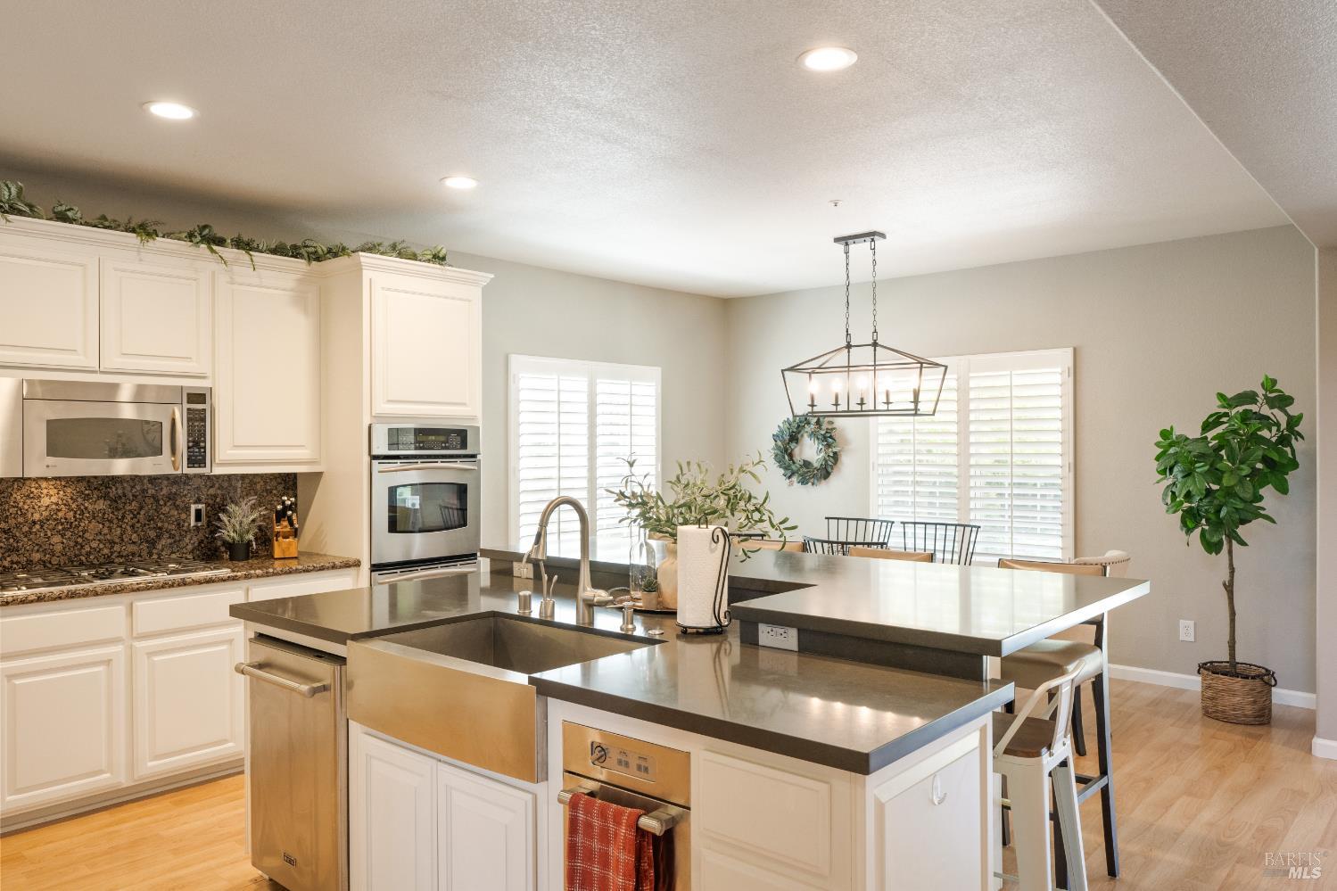1238 Darling Street Napa, CA 94558 - Photo 22 of 68 a kitchen with stainless steel appliances granite countertop a sink a stove and a wooden cabinets