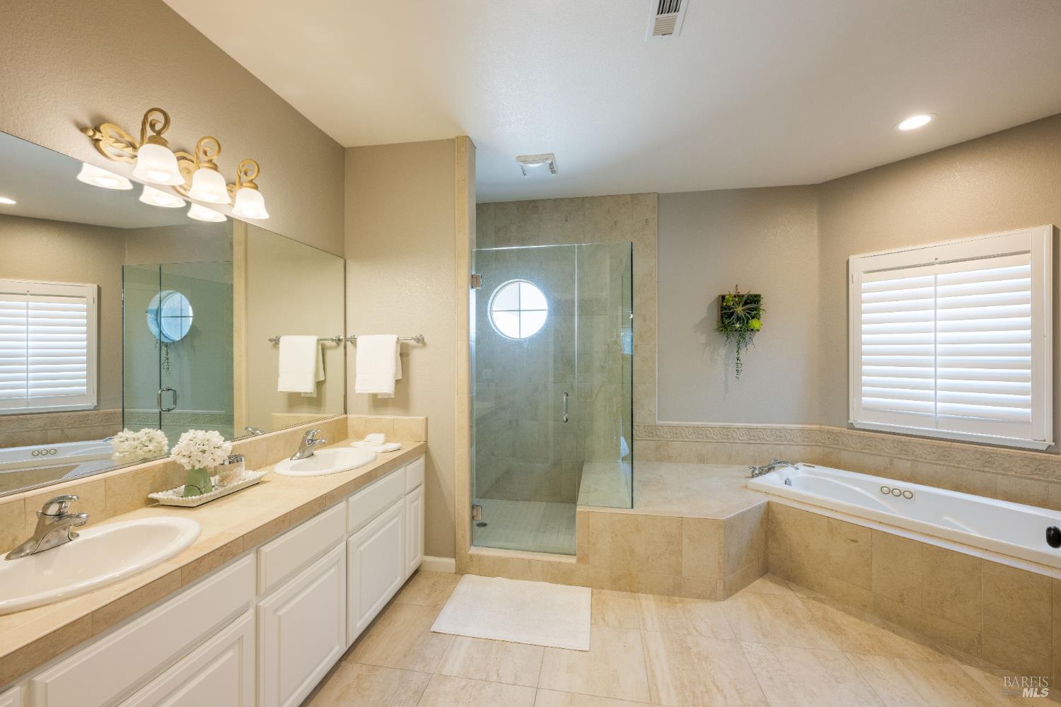 1238 Darling Street Napa, CA 94558 - Photo 50 of 68 a spacious bathroom with a double vanity sink a large mirror and a bathtub