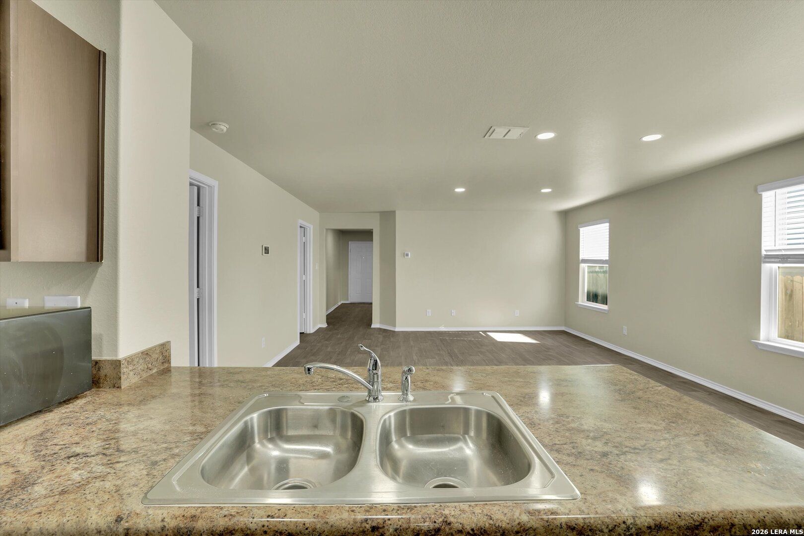 7639 Hercules Point San Antonio, TX 78252 - Photo 11 of 28 a kitchen with a sink granite counter tops and a granite counter tops