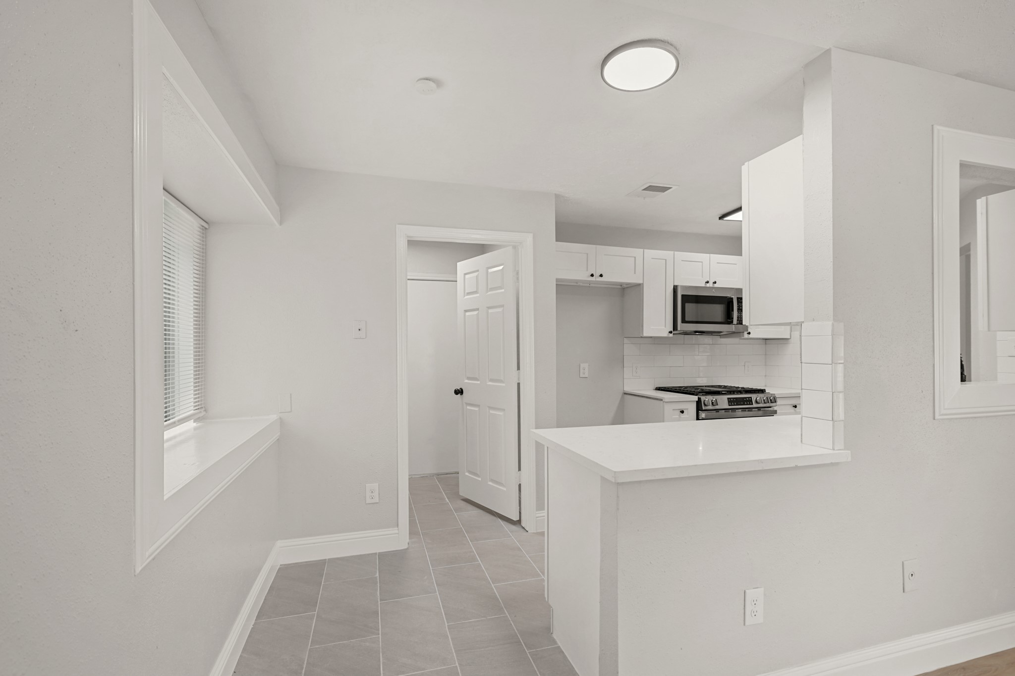 3623 Peachstone Place Spring, TX 77389 - Photo 8 of 20 a room with stainless steel appliances white cabinets and wooden floor