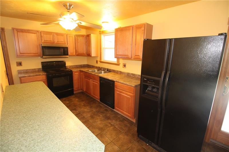 166 Francis Road Pittsburgh, PA 15239 - Photo 5 of 22 The kitchen is complete with black appliances throughout and a ceiling mounted light/fan...