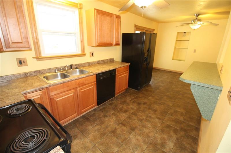 166 Francis Road Pittsburgh, PA 15239 - Photo 6 of 22 The kitchen is equipped with a wall mounted counter for eat-in capabilities and is immediately adjacent to the tiled dining room area...