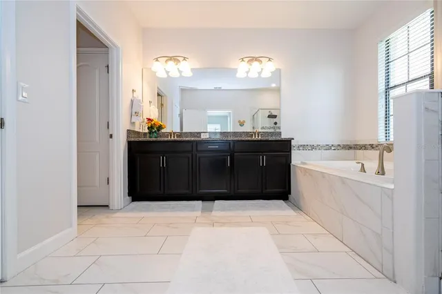 a bathroom with a bathtub and a sink