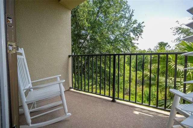 a view of a balcony with wooden floor