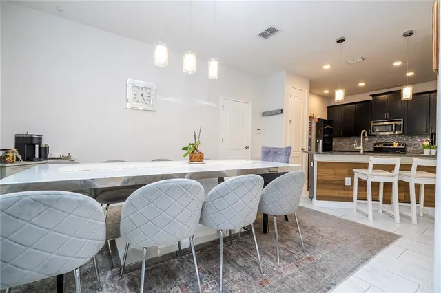 a kitchen with kitchen island a sink appliances and cabinets