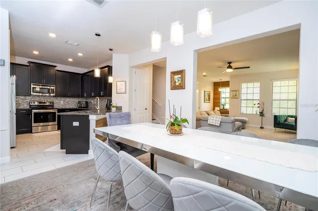 a kitchen with kitchen island granite countertop a sink cabinets and stainless steel appliances