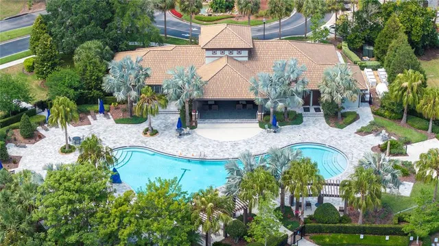 an aerial view of a house with swimming pool outdoor seating and yard