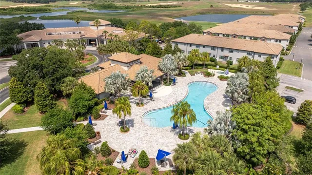 an aerial view of a house with a lake view