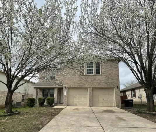 a front view of a building with trees