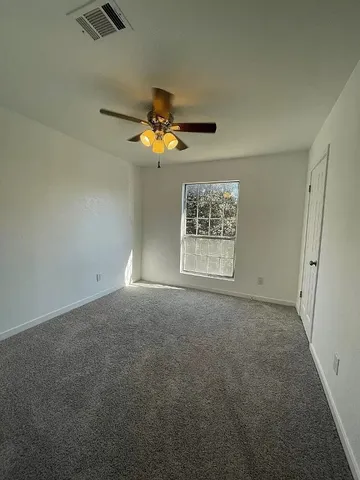 a spacious bathroom with a tub sink and mirror