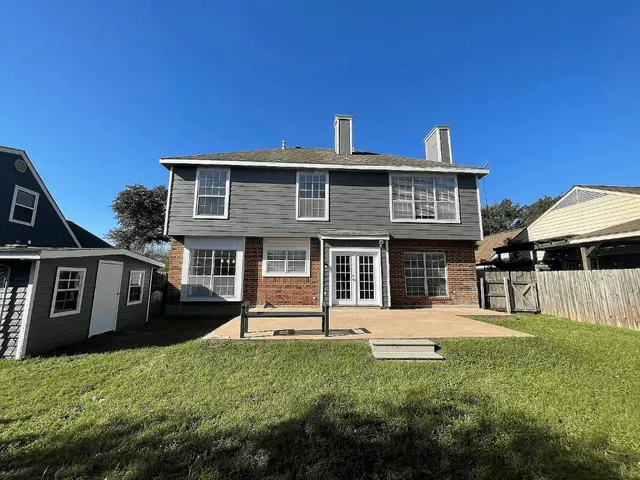 a front view of a building with trees