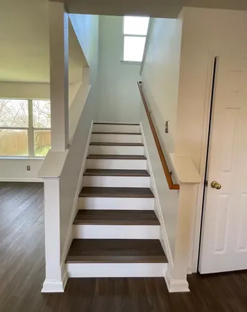 a view of entryway with wooden floor and stairs