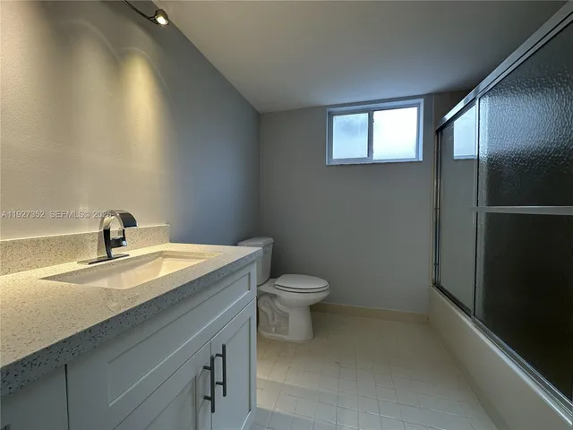 a front view of a house with a garden and yard