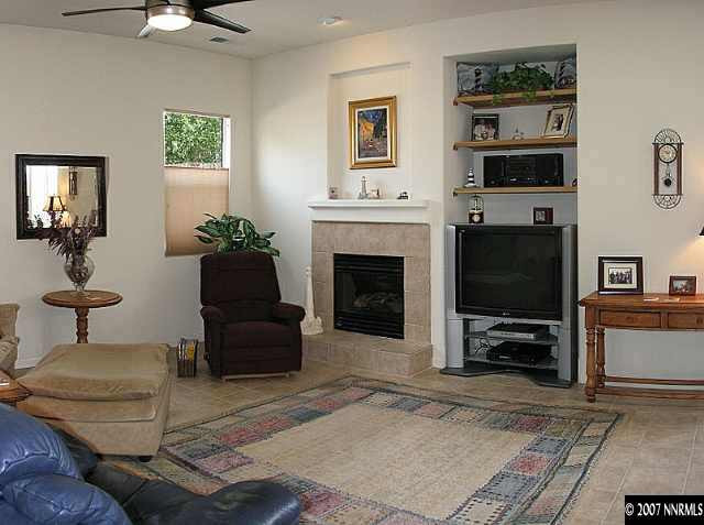 10490 Gold Arrow Drive Reno, NV 89521 - Photo 4 of 9 a living room with furniture a flat screen tv and a fireplace