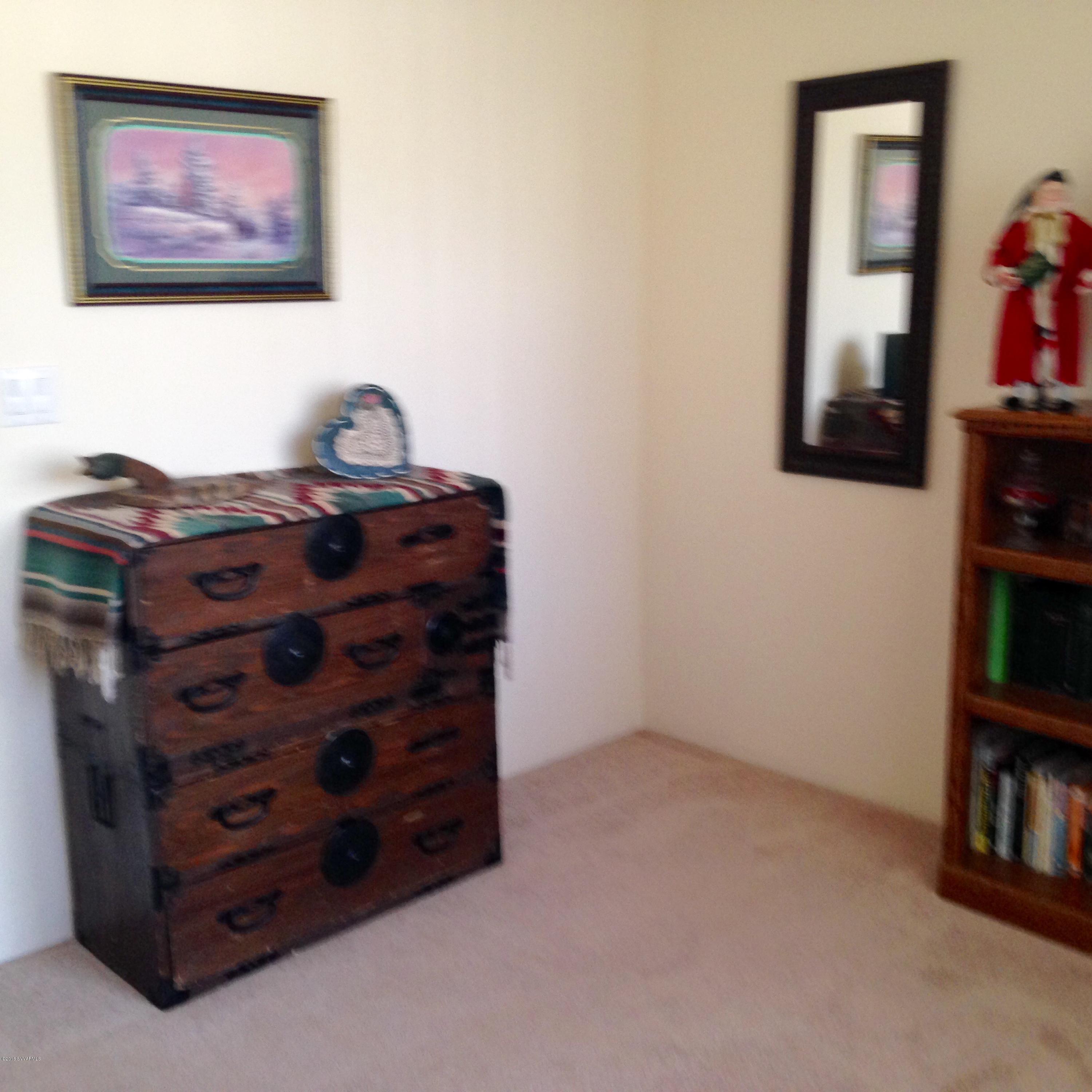 3749 East Beaver Vista Road Rimrock, AZ 86335 - Photo 18 of 26 a room with a dresser and a book shelf