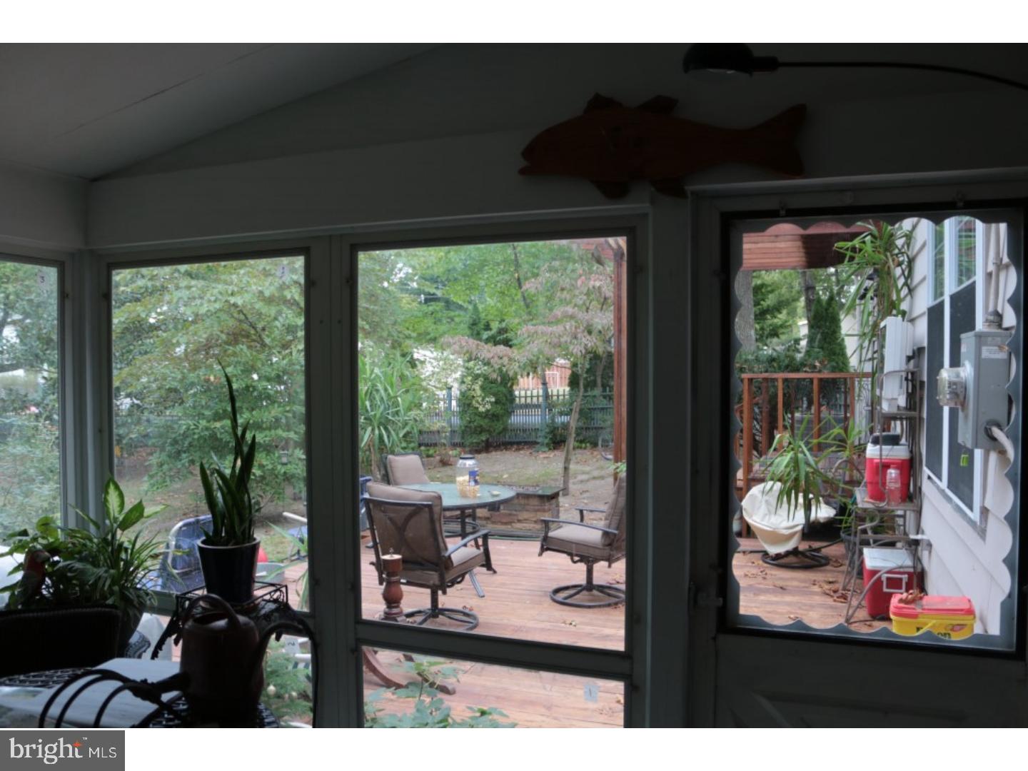 401 Swarthmore Road Glassboro, NJ 08028 - Photo 13 of 20 a view of a porch with dining table and chairs